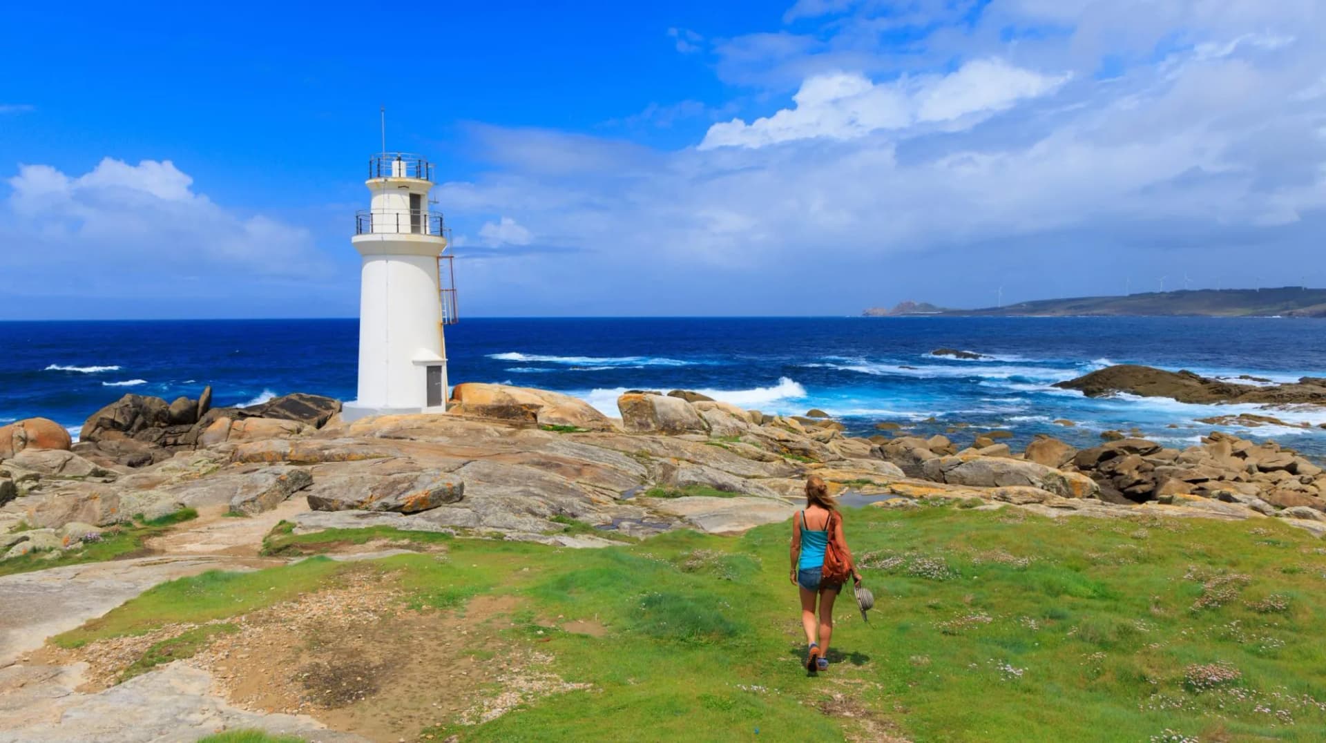 Traveler woman tourist visiting Galicia- Punta da barca, Muxia in Spain