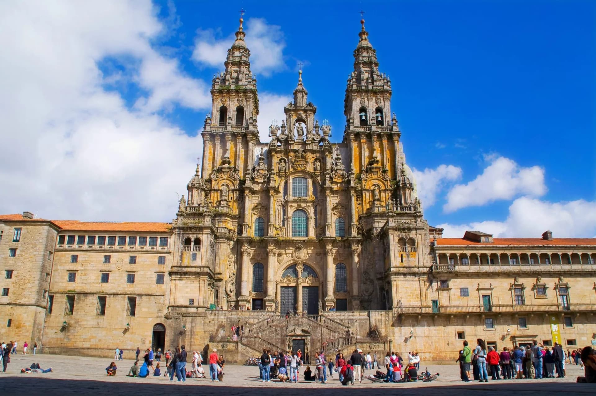 Cathedral of Santiago de Compostela facade with ornate towers and people in the square.