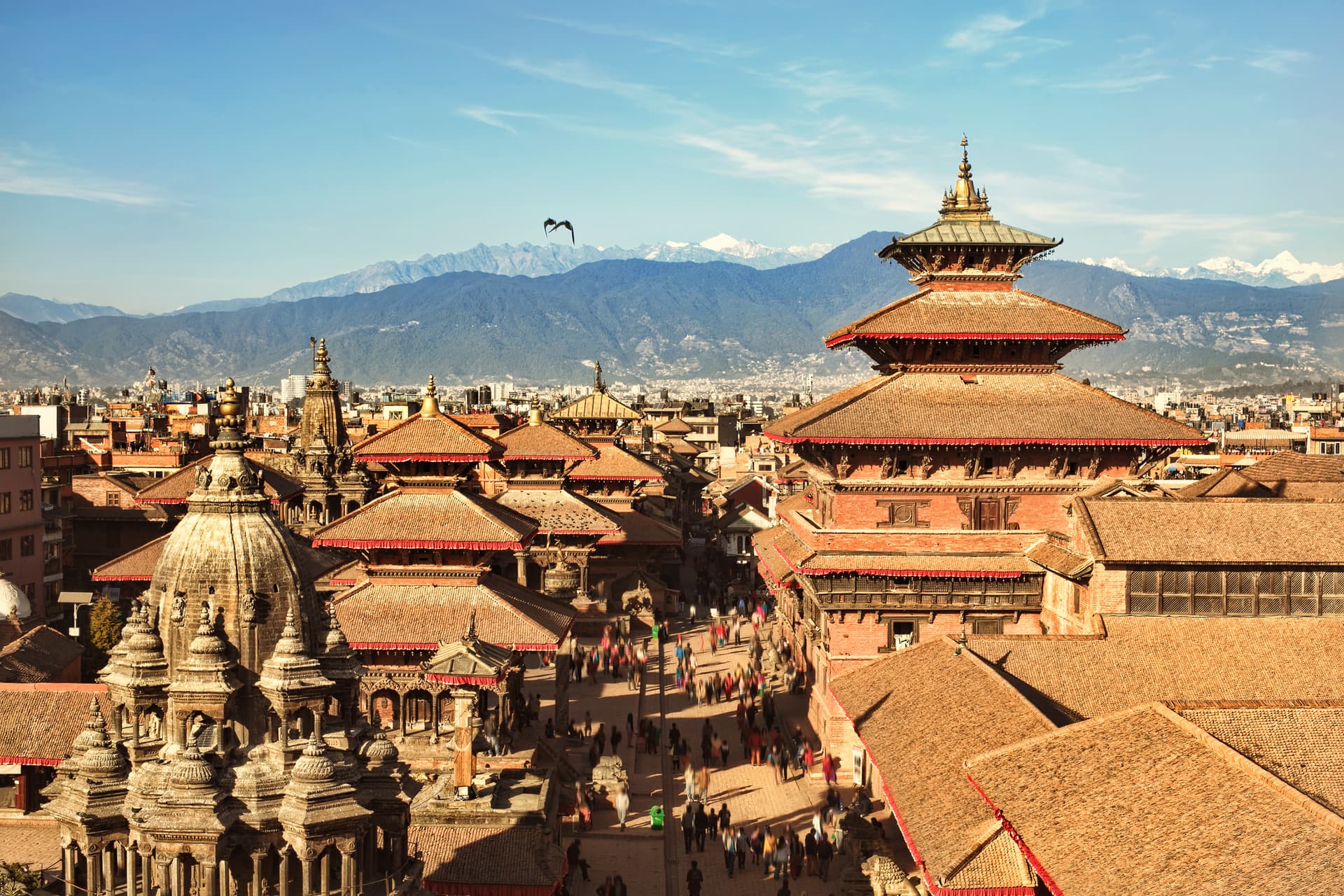Aerial view of Kathmandu Durbar Square temples with Himalayan mountains in background