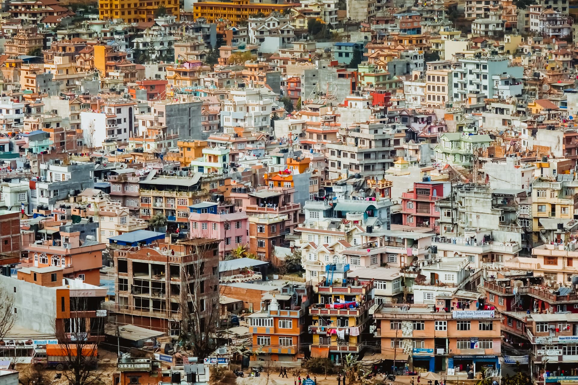 Dense urban sprawl of colorful residential buildings viewed from above in Kathmandu.