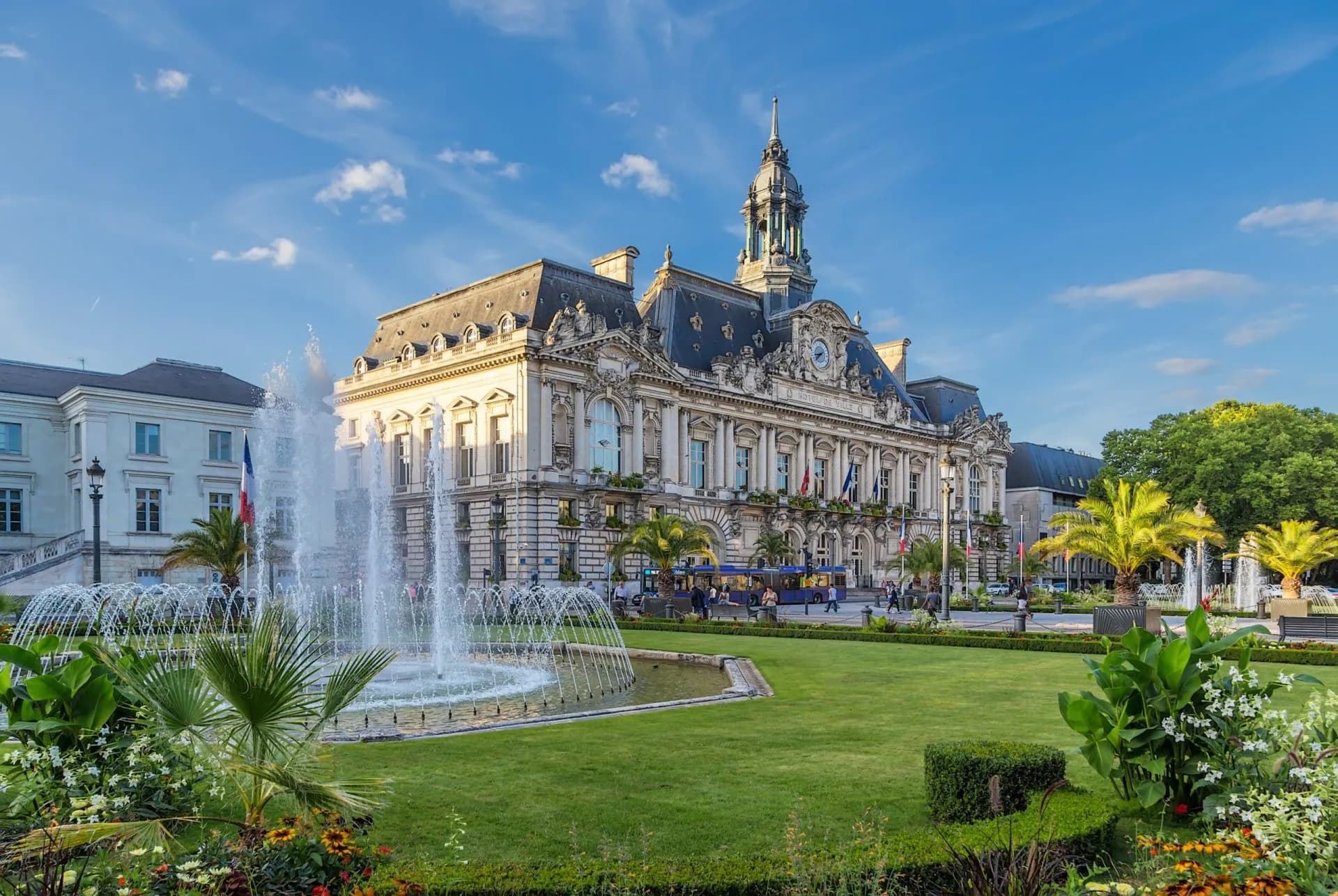 City Hall at Jean Jaurès Square in Tours with a large fountain and green lawn.
