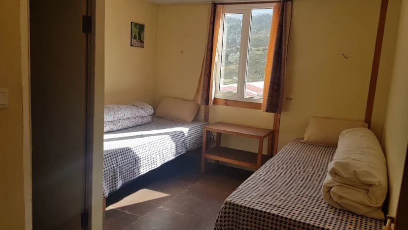 Twin room in Hotel New EBC Lobuche with mountain view through window