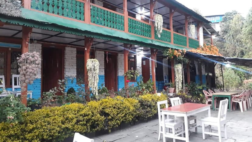 Jhinu Guest House with outdoor seating area and hanging plants