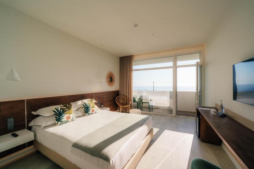 Bright hotel room with sea view balcony at Porto-Covo Praia Hotel and SPA