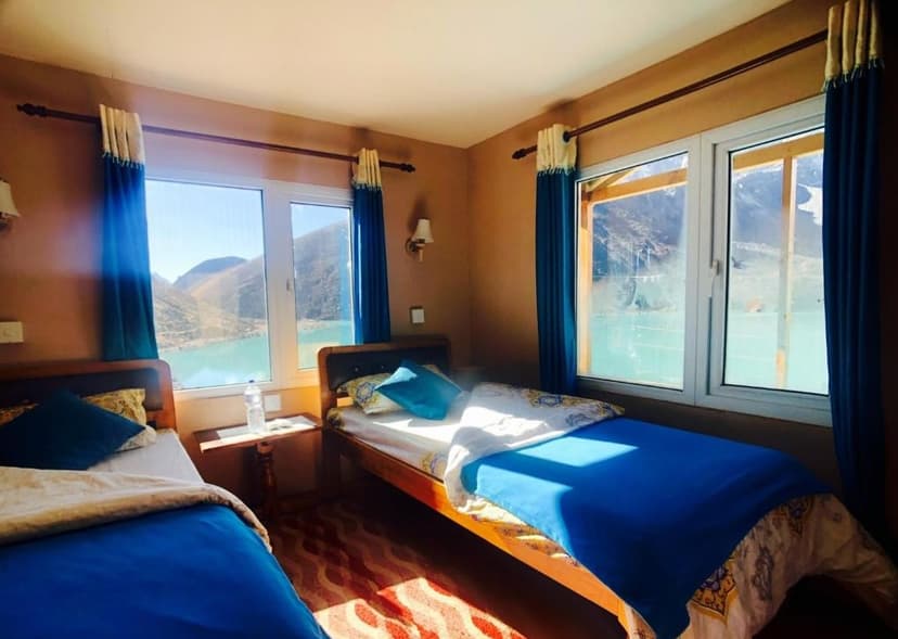 Twin bedroom in Gokyo-Thanaka Inn with mountain and turquoise lake view