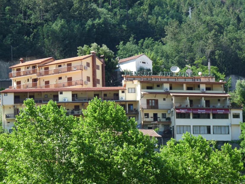 Pensão Adelaide hotel building nestled in lush green hillside forest in summer