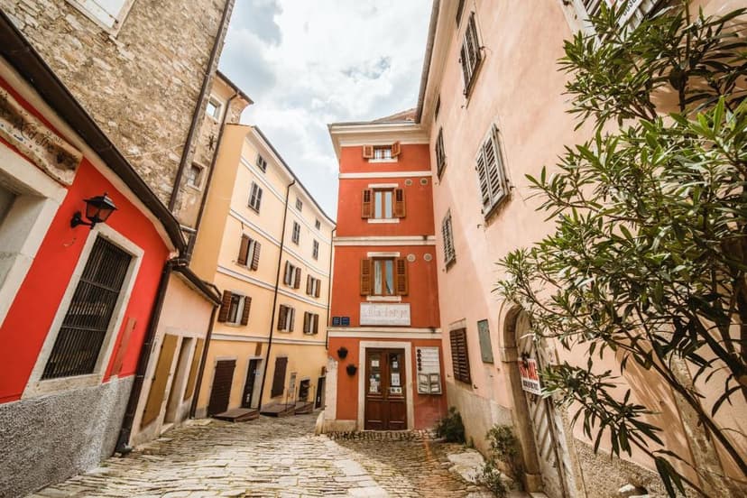 Cobblestone alley with colorful historic buildings, including Villa Borgo B&B entrance.