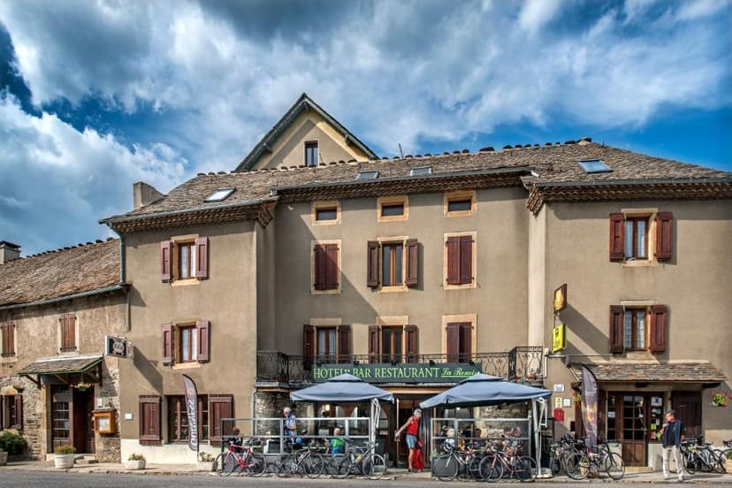 Hotel Bar Restaurant La Remise with bicycles parked outside under cloudy sky