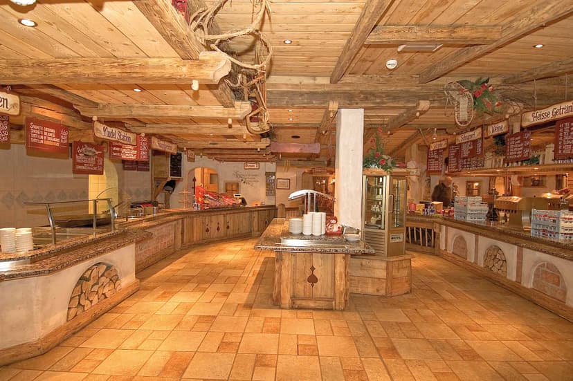 Rustic wooden interior of Buchau Hut with serving counters and tiled floor