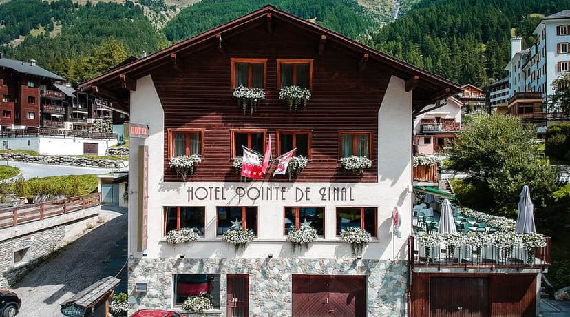 Hotel Pointe de Zinal building facade with flower boxes in an alpine village setting.