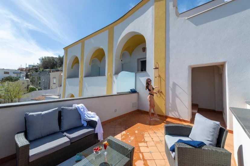Rooftop terrace of Albadamare Boutique Hotel with outdoor shower and seating area