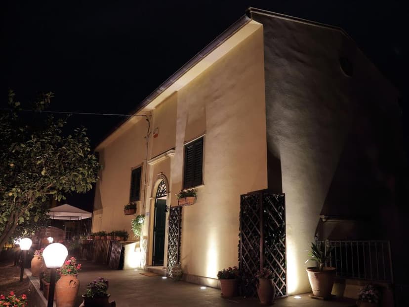 Illuminated building exterior at night with potted plants and garden lights, La Terrazza sulla Valle
