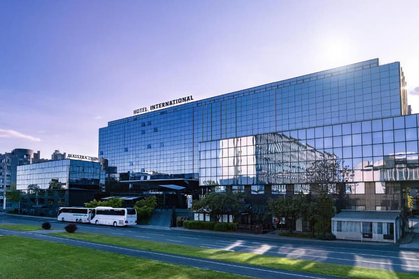 Hotel International by Maistra with glass facade, buses parked, and sunny sky