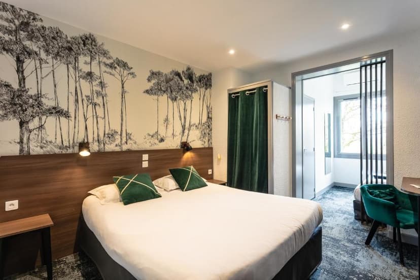 Hotel bedroom with mural of tall trees, white bedding, and green accent pillows.