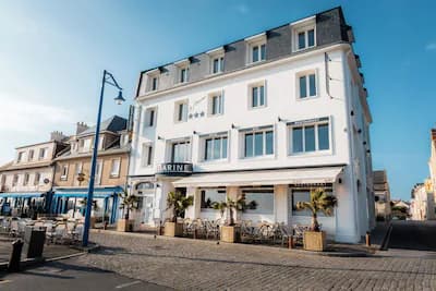 Le Grand Hôtel de la Marine with outdoor cafe seating on a cobblestone street.