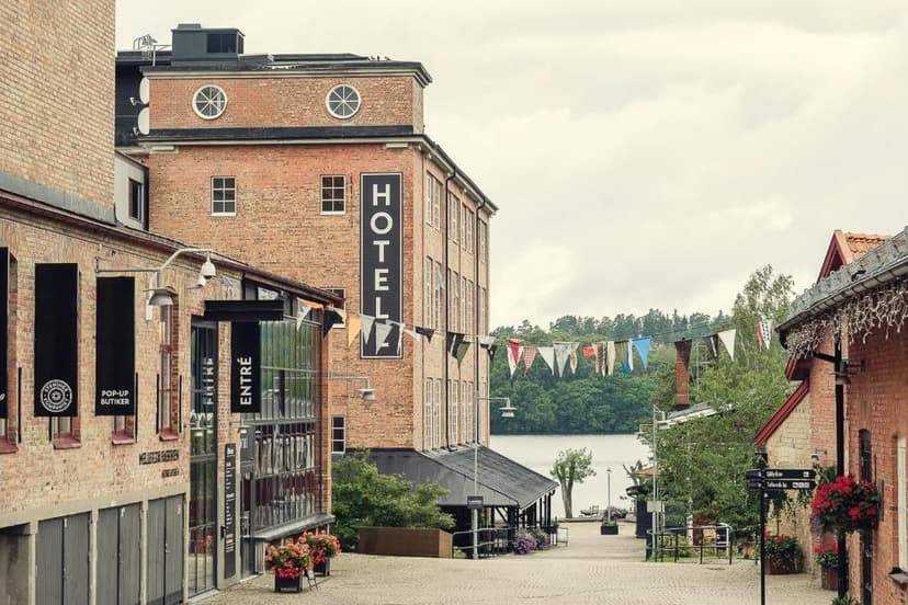 Brick hotel building on street leading to lake in Nääs Fabriker area.