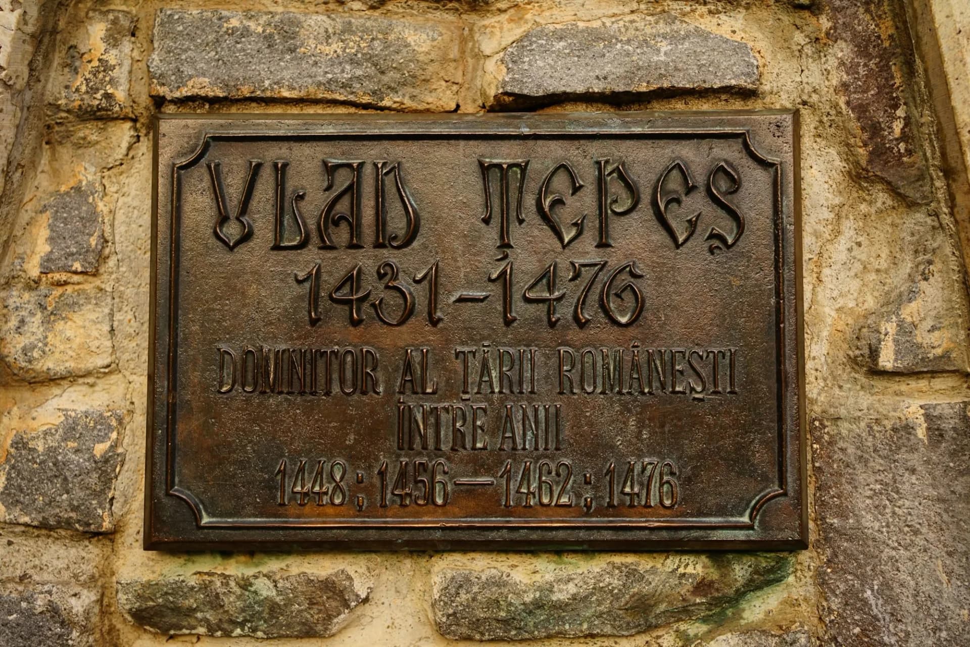 Bronze plaque for Vlad Tepes (1431-1476) mounted on a rough stone wall in Sighisoara.