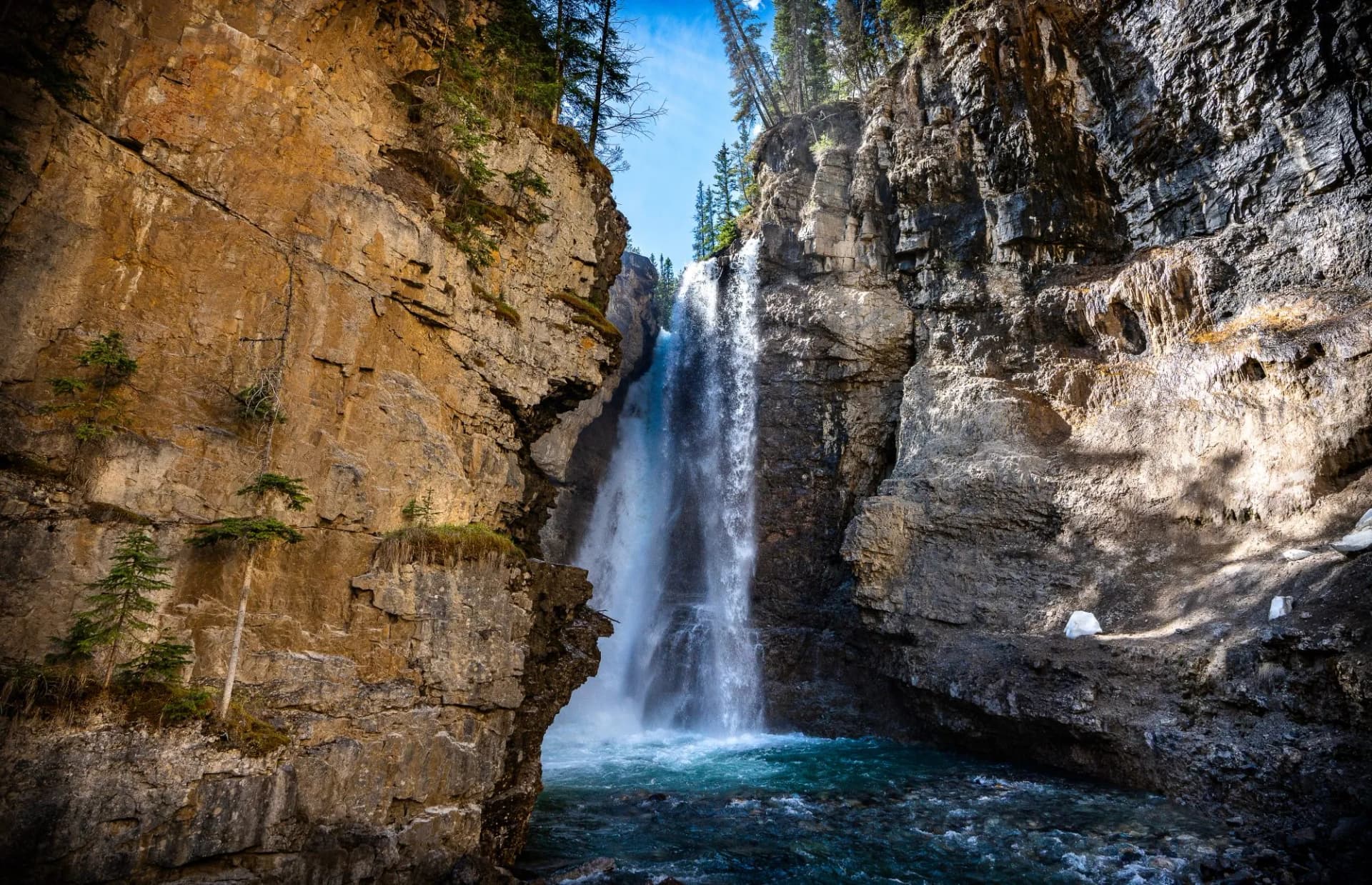 Waterfall landscape in Johnston Canyon in Banff National Park in Alberta Canada on a sunny summer day.