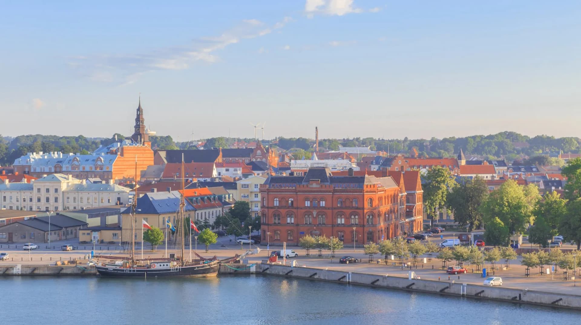 Ystad, Baltic coast, south Sweden. View of waterfront and city in rays of rising sun