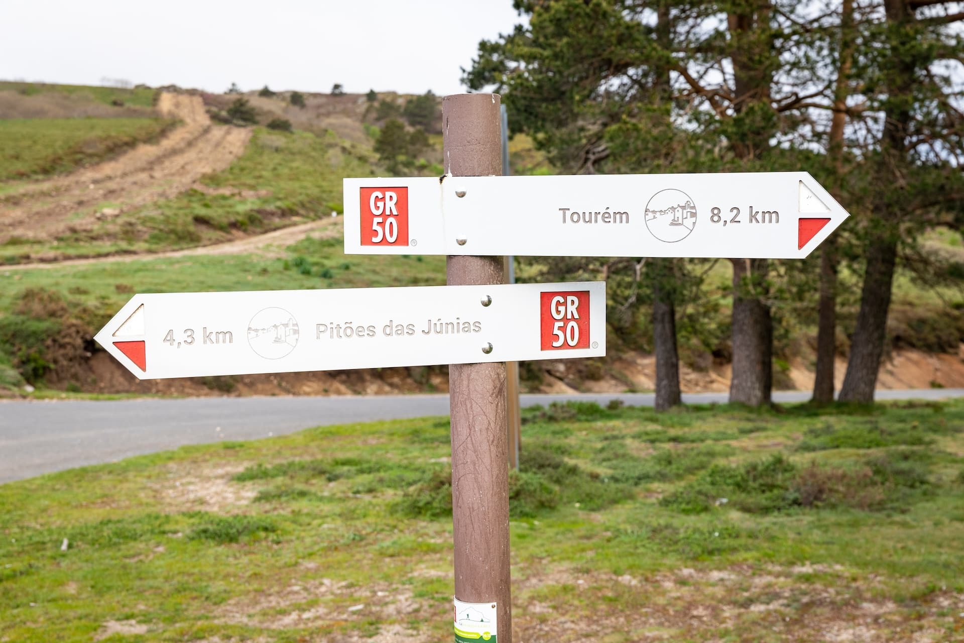 GR 50 trail sign pointing to Tourém and Pitões das Júnias in Peneda-Gerês National Park.