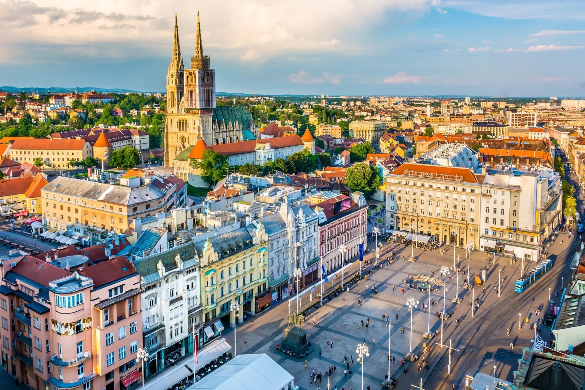 Zagreb Cathedral towers over the city center and main square with historic European architecture.