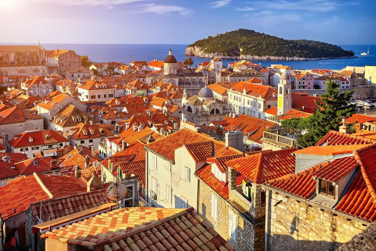 Rooftops of Dubrovnik old town with terracotta tiles overlooking the Adriatic Sea and Lokrum Island.