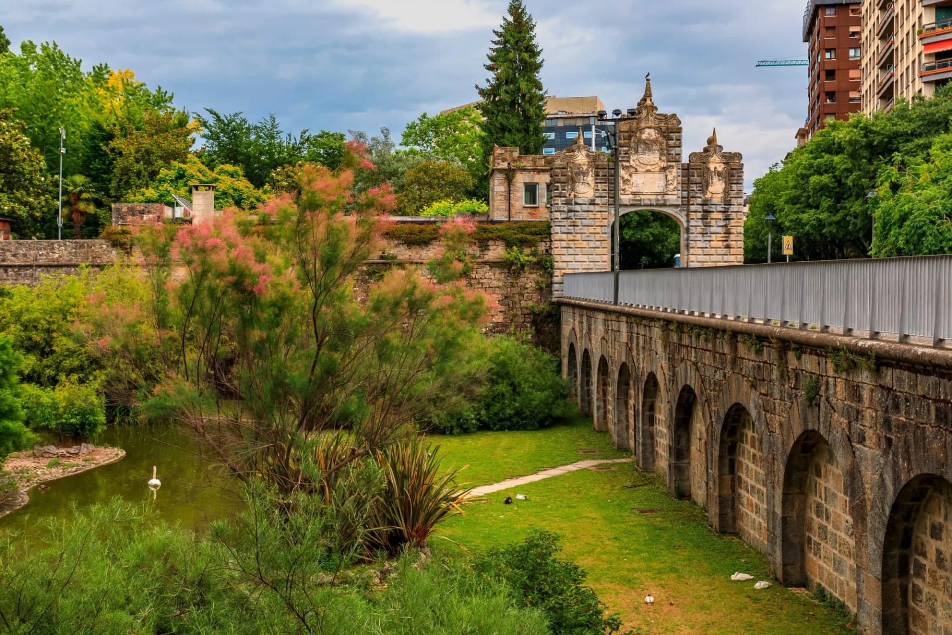 Taconera Gardens and Portal de la Taconera built in 1906 in Pamplona, Navarre, Spain on a cloudy day