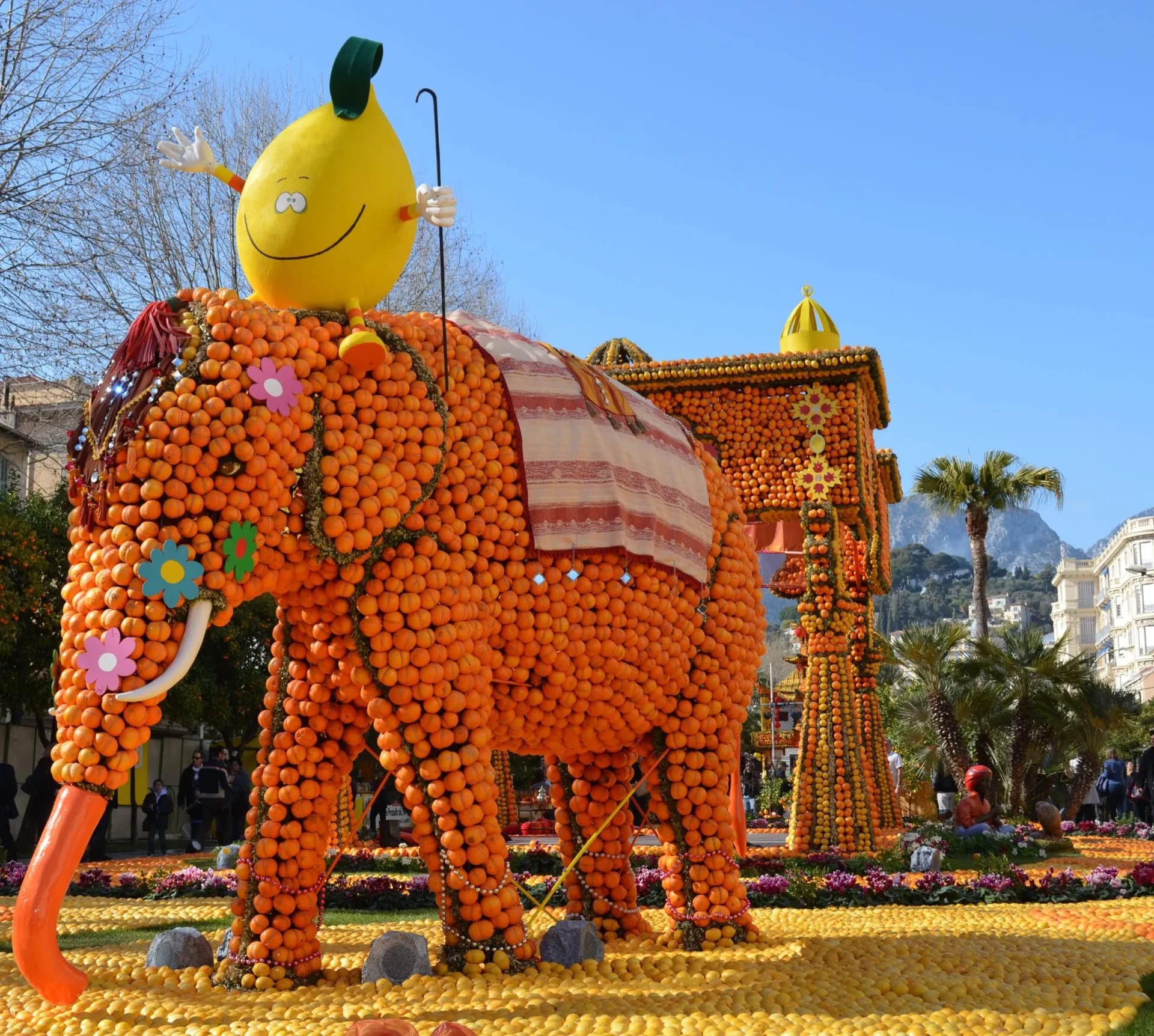 Elephant float made of oranges with lemon character, Menton Lemon Festival setting