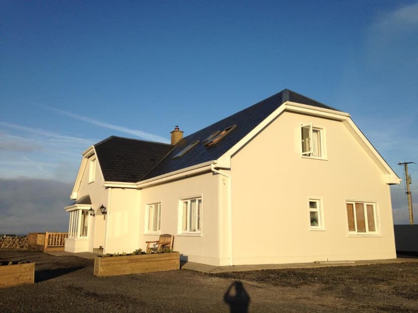 White Doolin View B&B building with dark roof under a bright blue sky