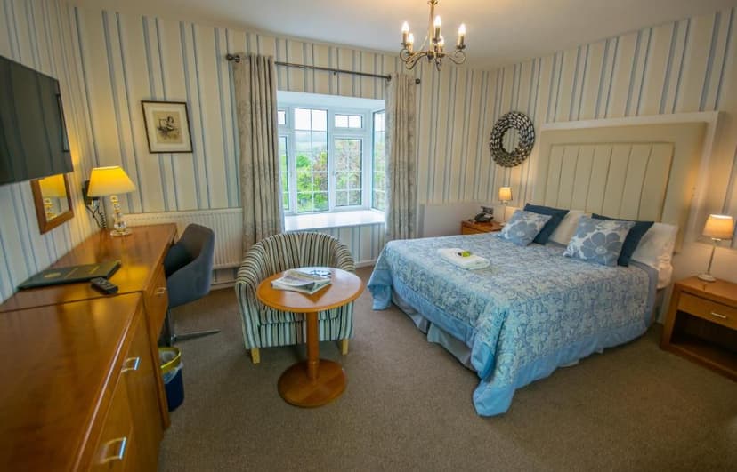 Bedroom in Old Kings Arms Hotel with blue striped wallpaper and blue patterned bedding