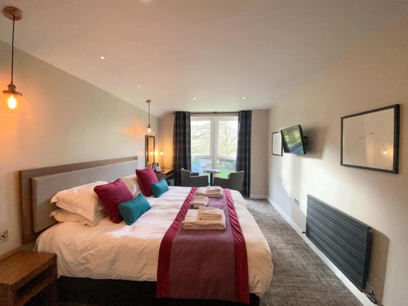 Hotel bedroom with large bed, modern lighting, and window view, Glaramara Hotel