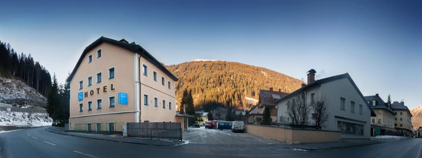 Hotel Residence AlpenHeart in alpine village with snow and forested mountain backdrop
