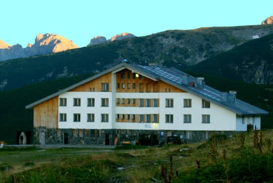 Rila Lakes Hut building in alpine setting with rugged mountains in the background