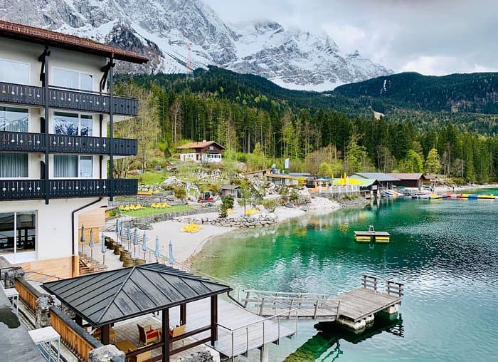 Eibsee Hotel on emerald lake with snow-capped alpine mountains in background