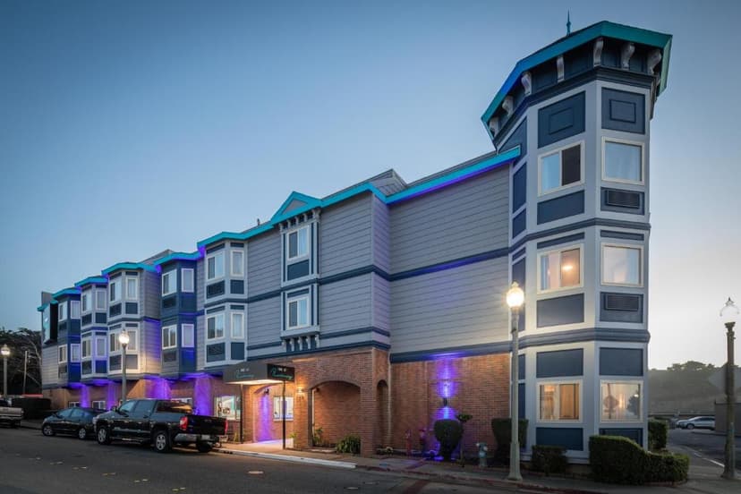 Inn at Rockaway hotel exterior with blue and gray siding and purple accent lighting in Pacifica.