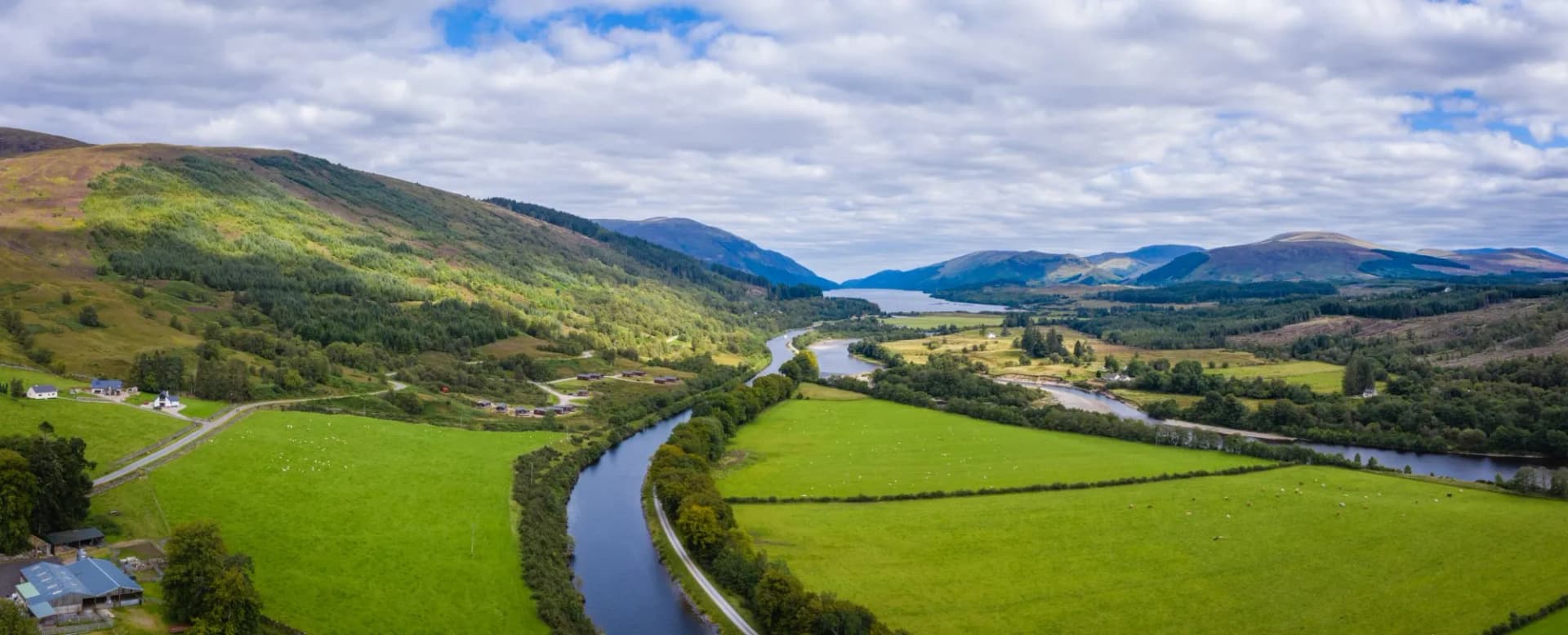 aerial drone footage of summer in gairlochy near fort william on the caledonian canal in the argyll region of the highlands of scotland showing the mountains of glencoe and the surrounding region
