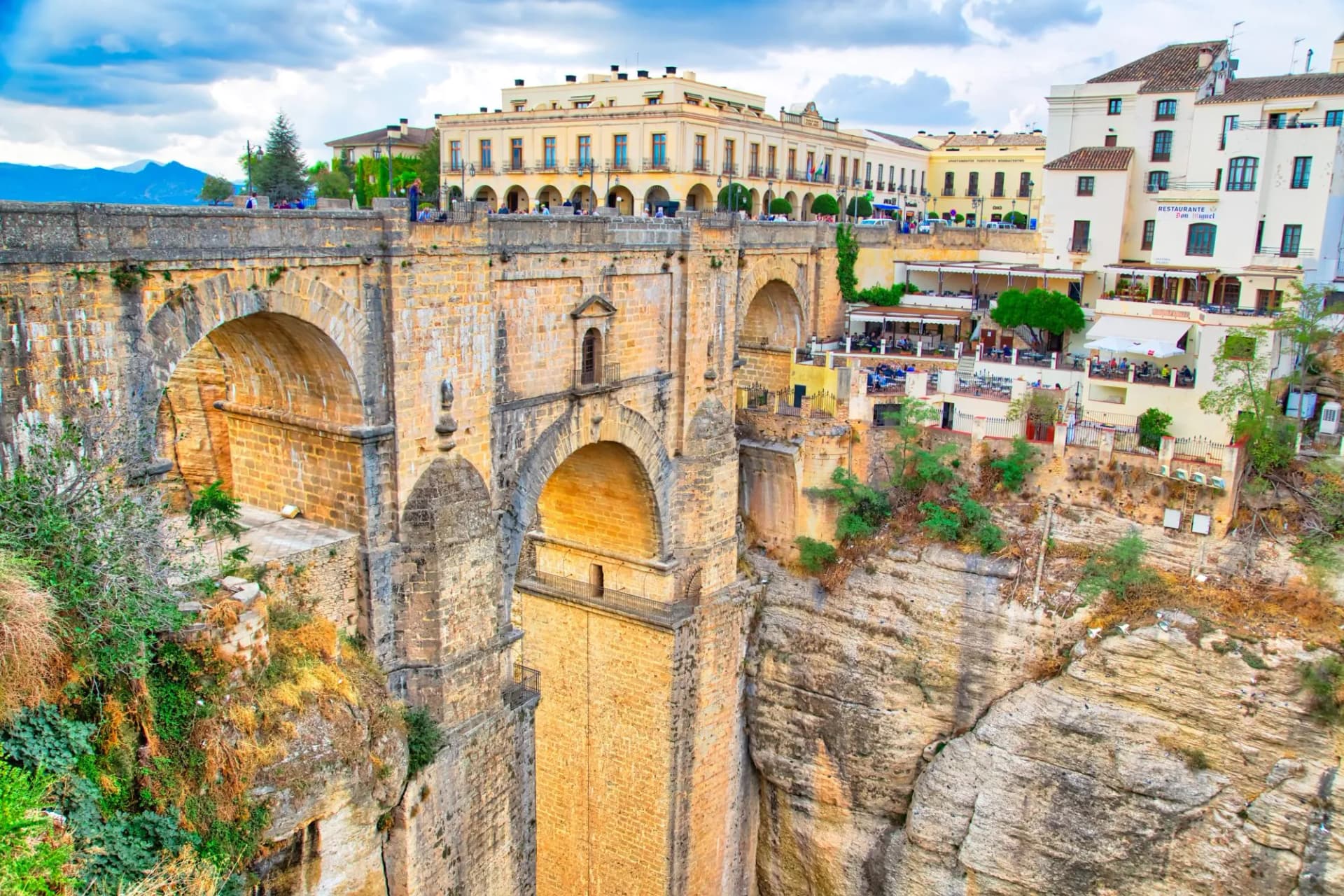 Puente Nuevo bridge arch over deep gorge in Ronda historic city center, Spain.