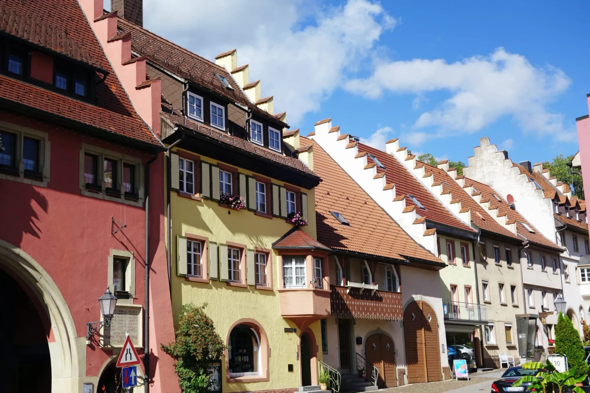 Colorful historic buildings with stepped gables and red tile roofs in Loffingen.