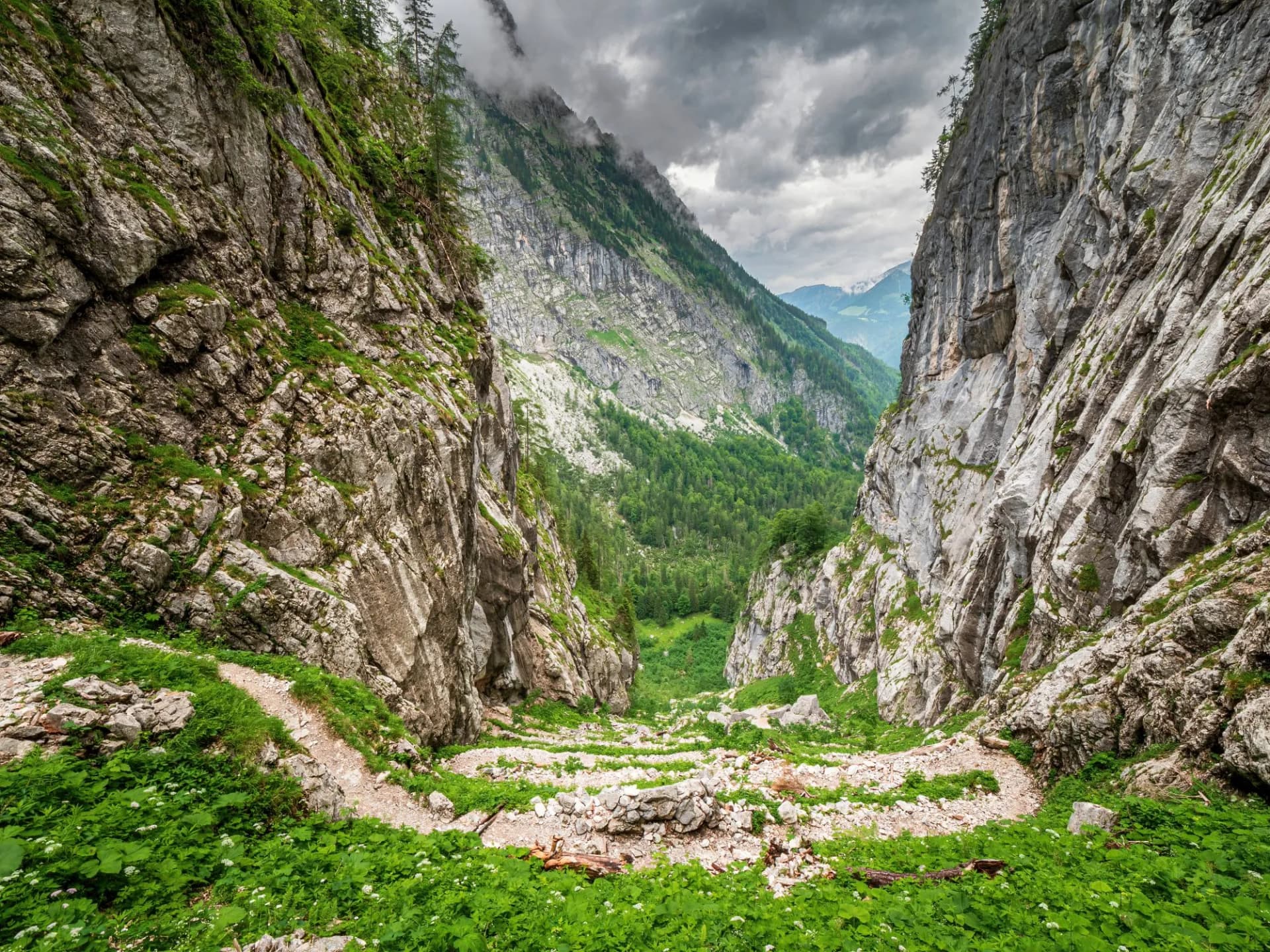Berchtesgaden Saugasse Hike Trail down the valley with rain clouds at the background
