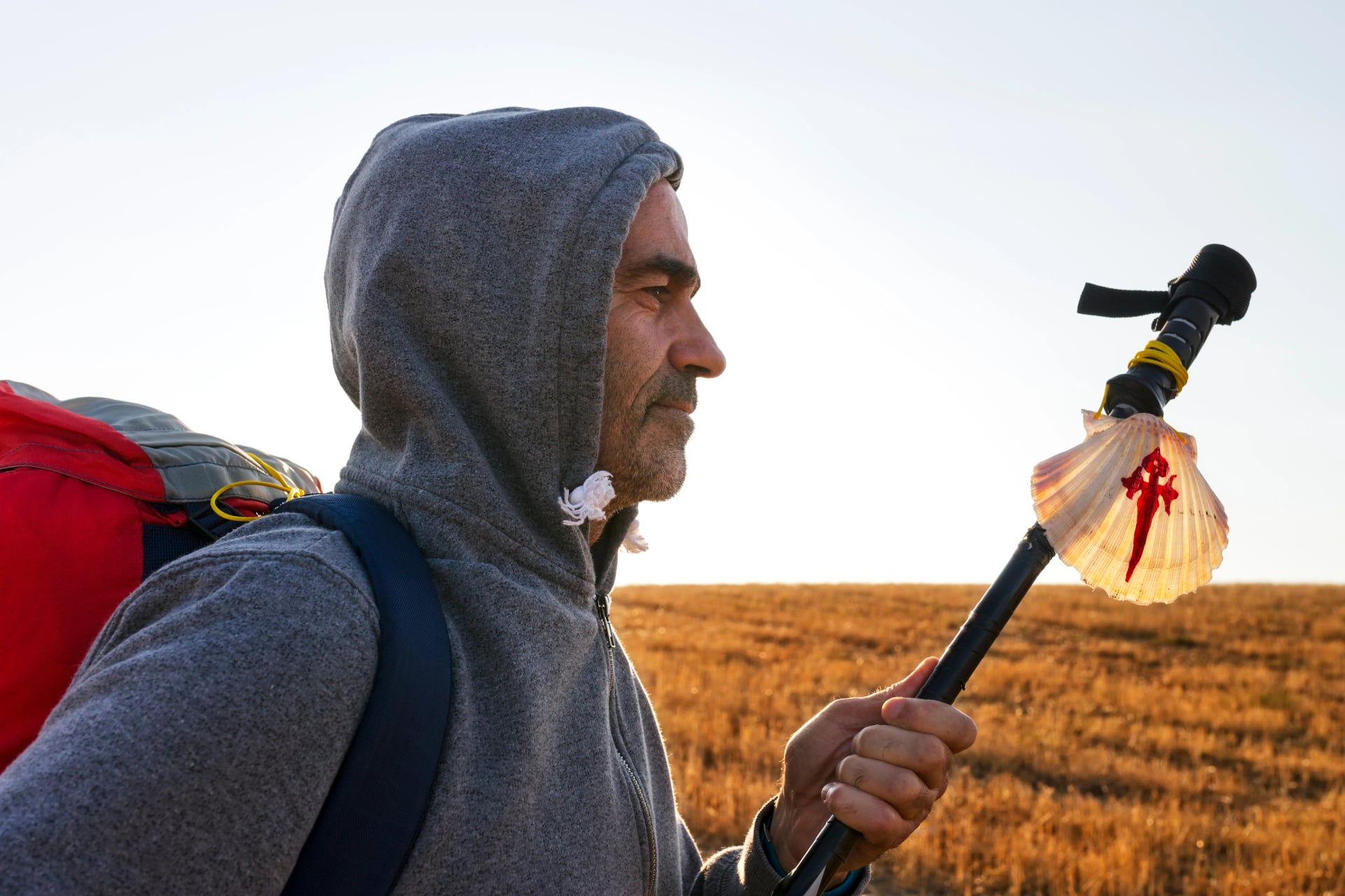 Camino de Santiago to Compostela , pilgrim man with scallop symbol in Leon city , Spain
