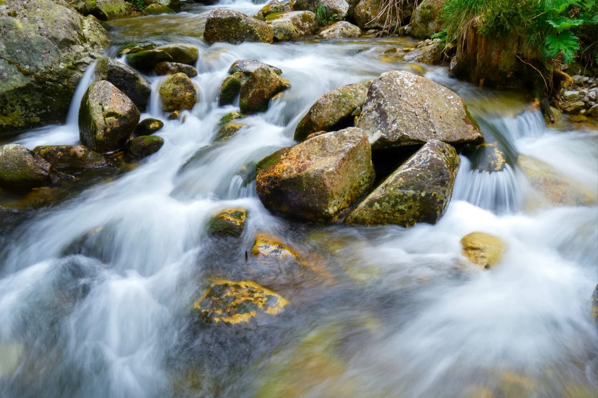 Long exposure of water flowing between rocks in Stanisoara river, Retezat mountains, near Pietrele Hut, in Romania.