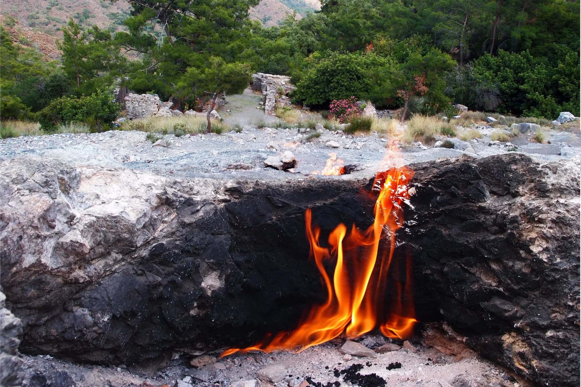 Flames of Chimera mount, burning natural gas underground, rocks in Cirali, Turkey