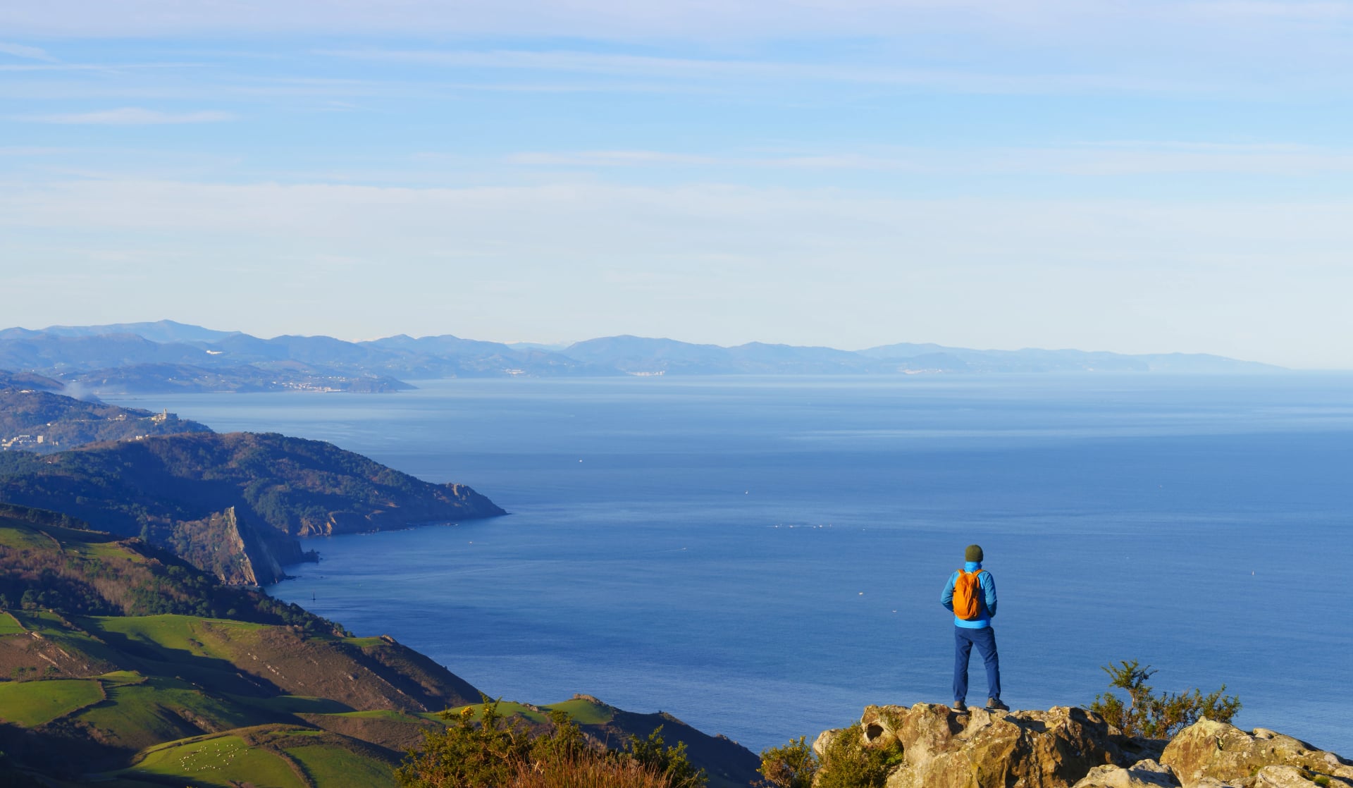 Hiker on the road to Santiago de Compostela. Pilgrim on the northern road, mount Jaizkibel, Euskadi.