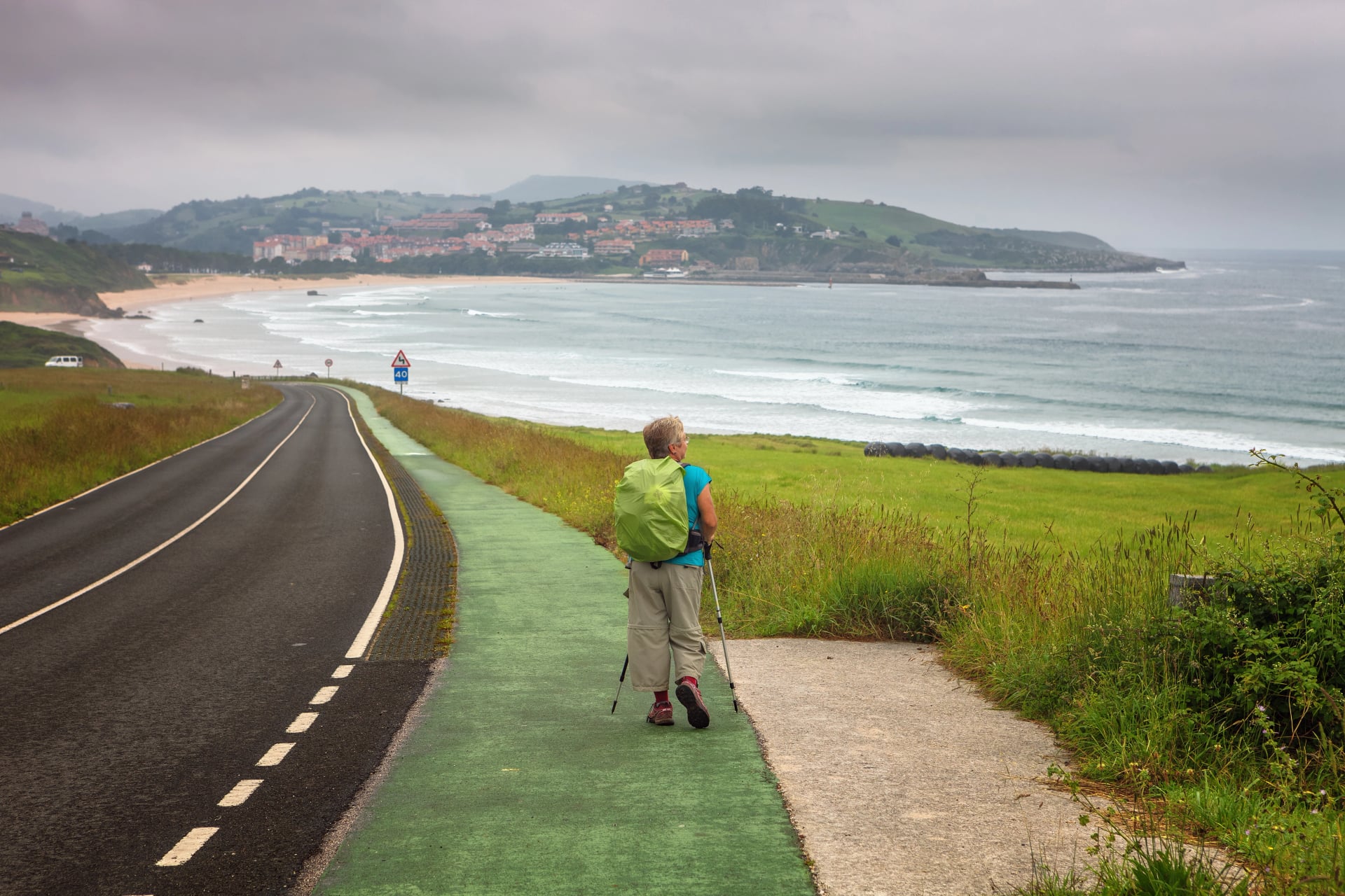 Pilgrim walking towards San Vicente de la Barquera, Cantabria, Spain