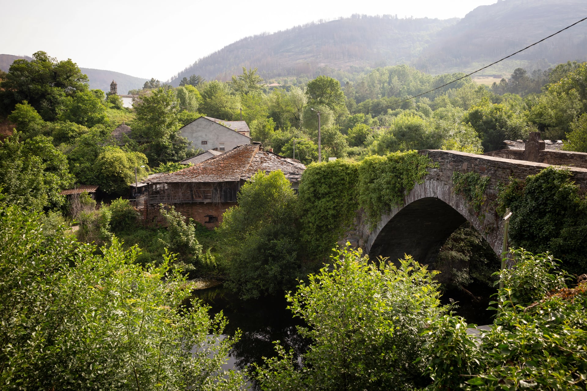Medieval bridge over Lor river in Barxa de Lor village (A Ponte), Quiroga A Pobra do Brollón, province of Lugo, Galicia, Spain - June 2022