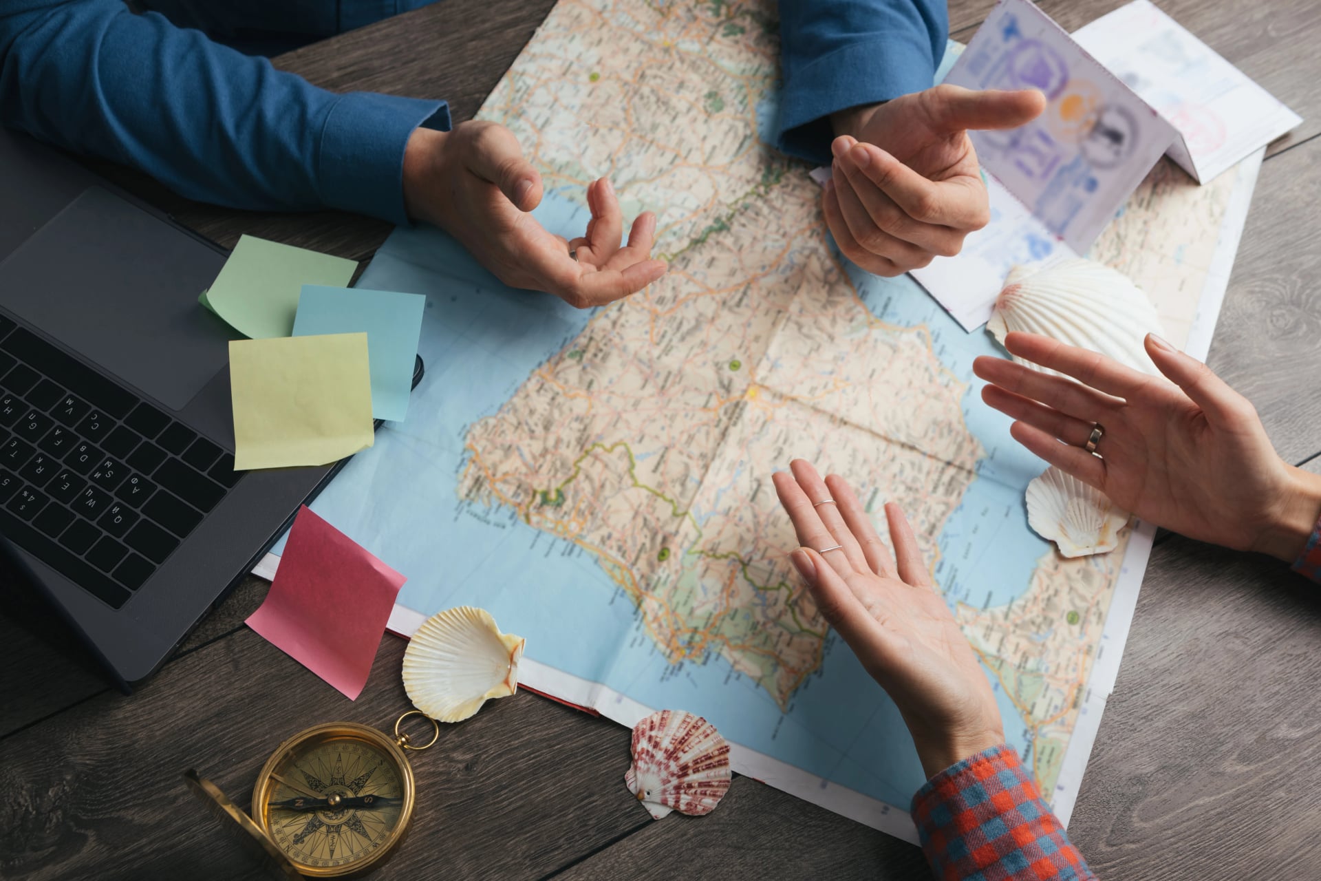 discussion and controversy planning travel. Couple reserching Europe map. Top view. Table with map hands and compass