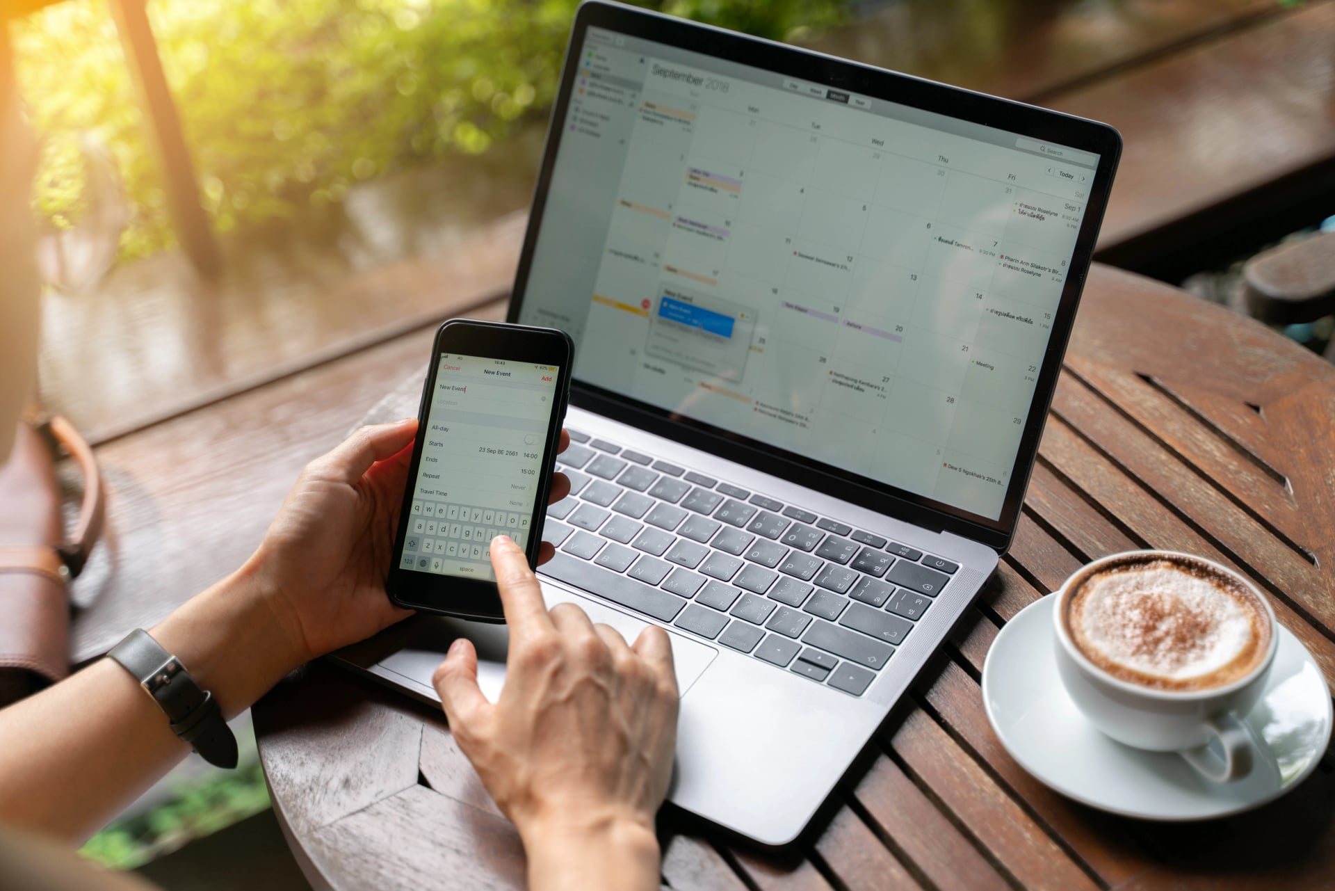 Close up of smartphone calendar create new event with on laptop