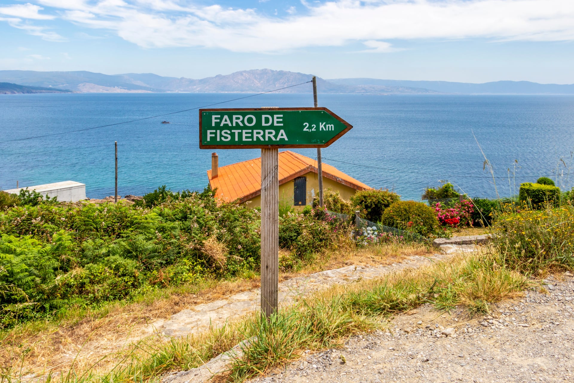 2,2 km to Faro de Fisterra, Fisterra lighthouse or Cape Finisterre - the end of the Way of St. James, Camino de Santiago distance sign at Fisterra, Galicia, Spain