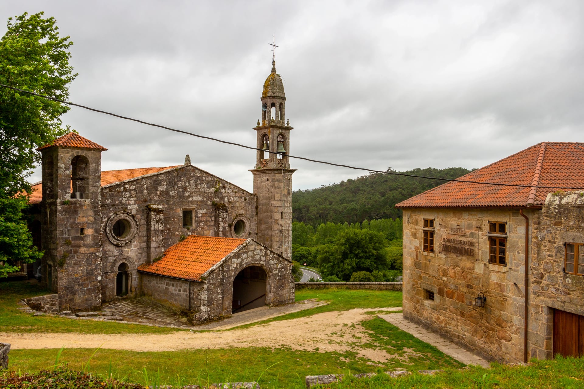 Church of San Xulian de Moraime with Monasterio de Moraime Hostel to the right on the Fisterra-Muxia Way of St. James in Moraime, Galicia, Spain