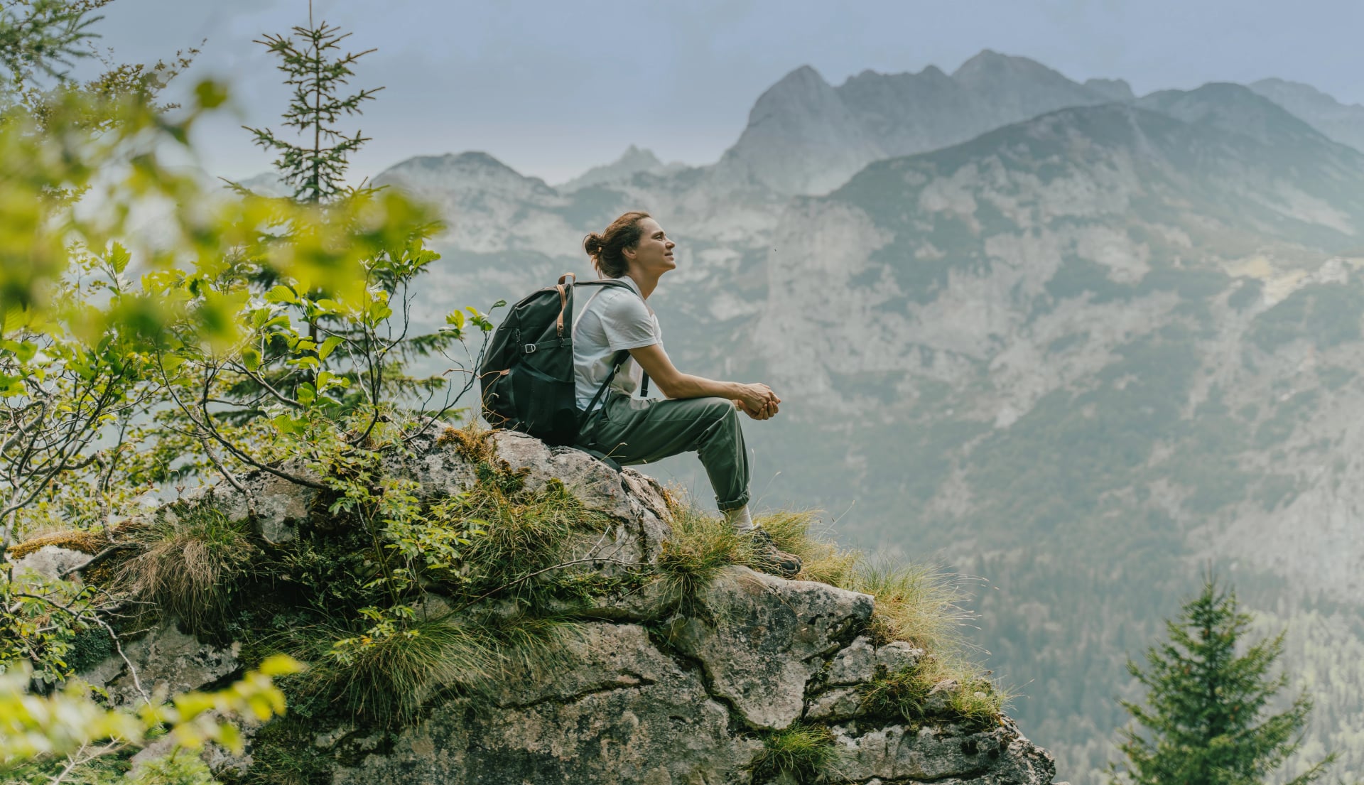 Woman Viewing Mountain Range and Forest Landscape During Hike or Adventure in Nature